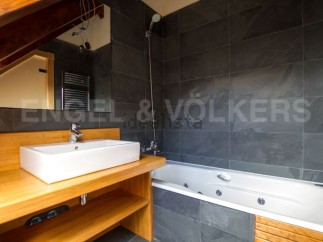 This stunning bathroom boasts a luxurious jacuzzi tub and modern sink, perfect for relaxation.