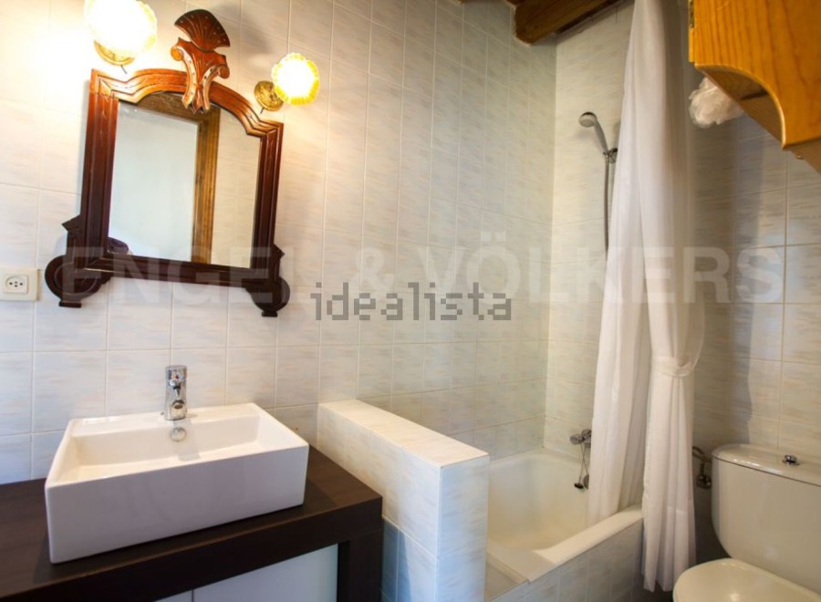 Charming bathroom with antique mirror and modern sink.