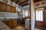 Rustic kitchen with wooden cabinets and granite countertops.
