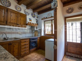 Rustic kitchen with wooden cabinets and granite countertops.