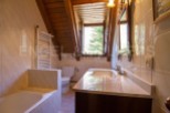 Charming bathroom with wooden beams and a view.
