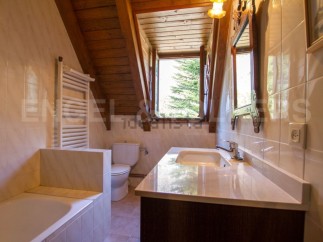 Charming bathroom with wooden beams and a view.