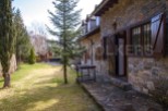 Charming stone house nestled in a serene mountain setting.