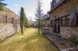 This charming stone house boasts a private garden, perfect for enjoying the mountain views.