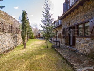 This charming stone house boasts a private garden, perfect for enjoying the mountain views.