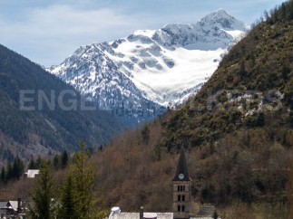 Nestled in a picturesque valley, this charming church boasts breathtaking views of snow-capped mountains.