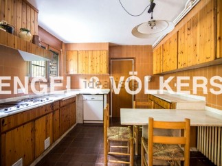 Rustic charm meets modern convenience in this kitchen, featuring wood cabinets and marble countertops.