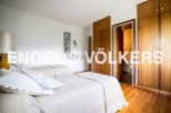 Charming bedroom with twin beds and built-in wooden wardrobes.