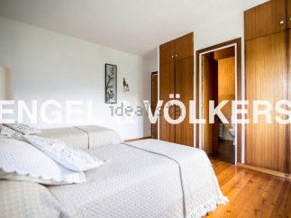 Charming bedroom with twin beds and built-in wooden wardrobes.