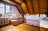 Charming attic bedroom with wooden beams and sloping ceilings.
