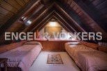 Charming attic bedroom with twin beds, wooden beams, and a cozy atmosphere.