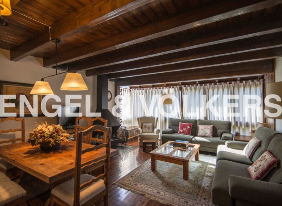 Charming rustic apartment with wooden beamed ceilings and a cozy fireplace.