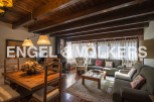 Charming rustic apartment with wooden beamed ceilings and a cozy fireplace.