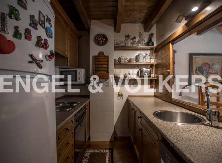 Charming kitchen with wooden cabinetry and granite countertops.
