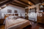 Charming attic bedroom with wooden beams and sloped ceilings.