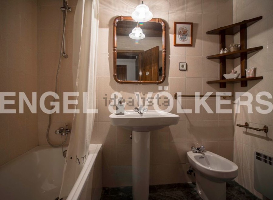 Charming bathroom with a pedestal sink, bathtub, and bidet.