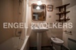 Charming bathroom with a pedestal sink, bathtub, and bidet.