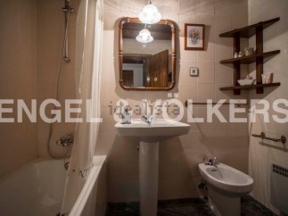 Charming bathroom with a pedestal sink, bathtub, and bidet.