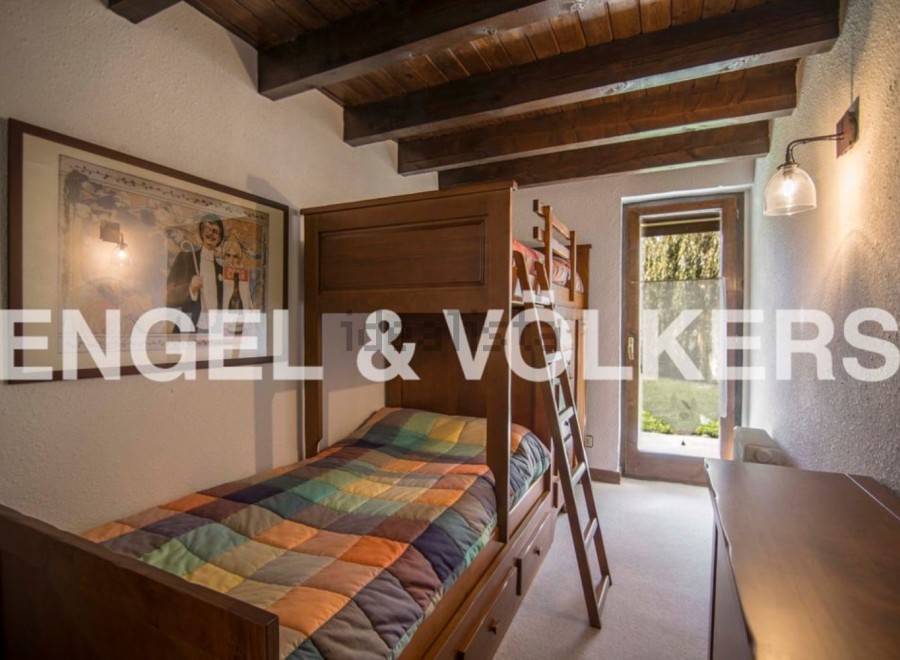 Charming wooden bunk bed in a cozy room, perfect for children.