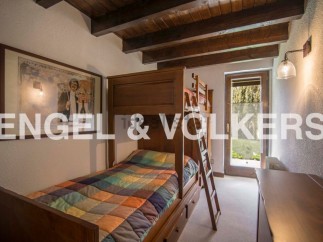 Charming wooden bunk bed in a cozy room, perfect for children.