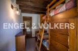Charming rustic bedroom with built-in bunk beds and ample storage.