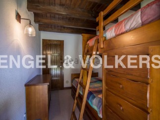 Charming rustic bedroom with built-in bunk beds and ample storage.