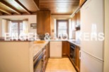 This charming kitchen boasts a rustic wooden ceiling and granite countertops, creating a warm and inviting atmosphere.