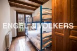 Charming wooden beamed bedroom with a built-in bunk bed, perfect for children or guests.