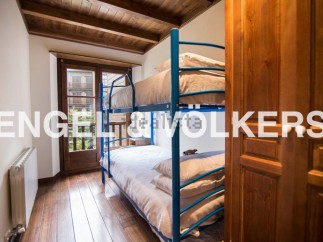 Charming wooden beamed bedroom with a built-in bunk bed, perfect for children or guests.