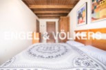 Charming bedroom with wooden ceiling and built-in wardrobe.