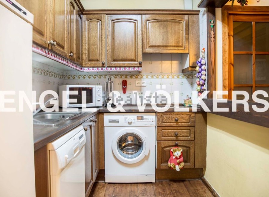 Cozy kitchen with wooden cabinets and modern appliances.