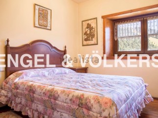 Charming bedroom with floral bedding and wooden headboard.