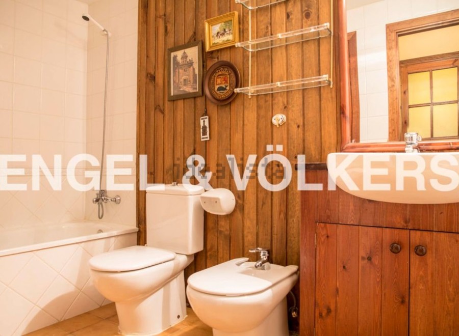 Charming bathroom with wooden walls and vintage decor.
