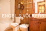 Charming bathroom with wooden walls and vintage decor.
