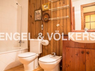 Charming bathroom with wooden walls and vintage decor.