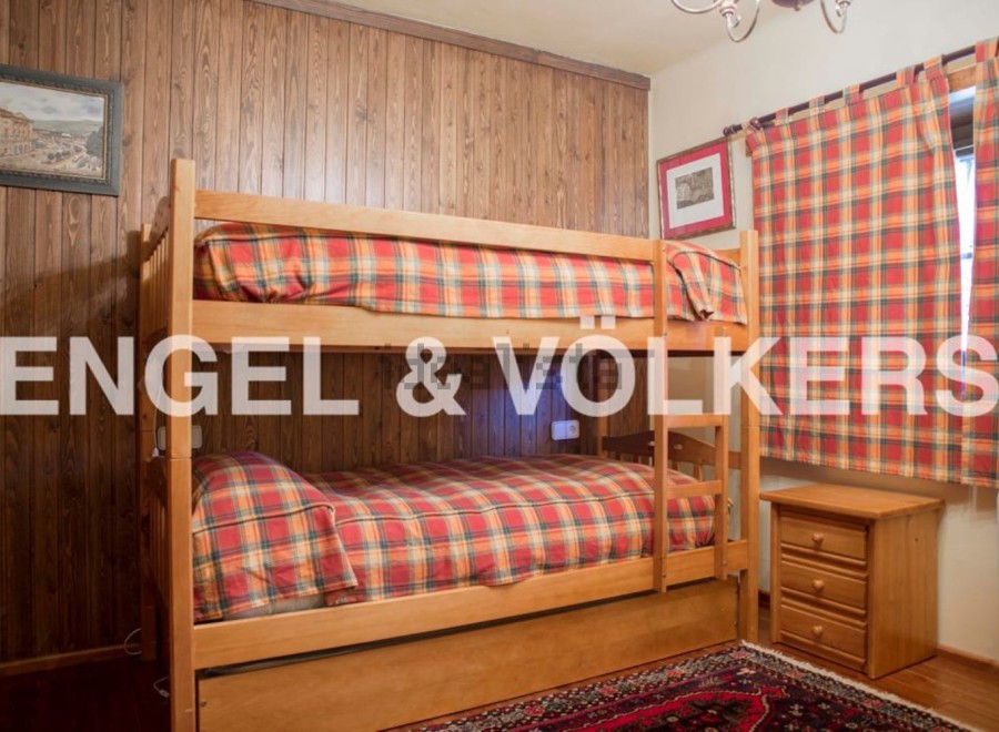 Cozy bunk beds in a charming wooden room, perfect for a family getaway.