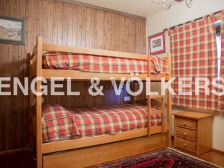 Cozy bunk beds in a charming wooden room, perfect for a family getaway.