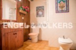 Charming bathroom with wooden vanity and tiled walls.