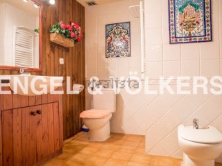 Charming bathroom with wooden vanity and tiled walls.