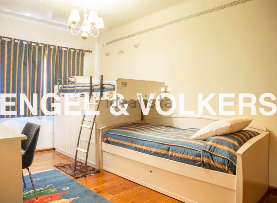 Charming children's bedroom with built-in bunk beds and trundle, perfect for sleepovers or siblings.