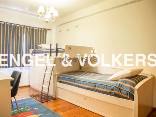 Charming children's bedroom with built-in bunk beds and trundle, perfect for sleepovers or siblings.