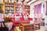 Cozy living room with built-in wooden bookcase, offering ample storage.