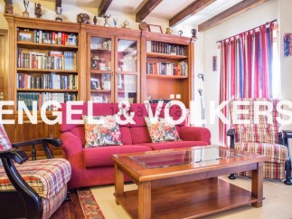 Cozy living room with built-in wooden bookcase, offering ample storage.