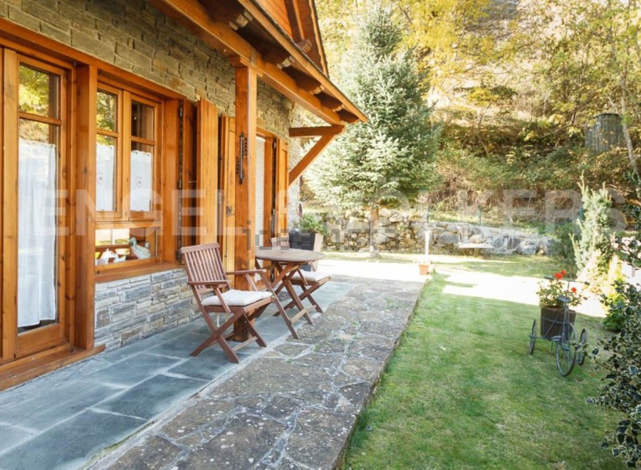 This charming stone and wood cabin boasts a spacious patio perfect for outdoor relaxation.