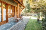 This charming stone and wood cabin boasts a spacious patio perfect for outdoor relaxation.