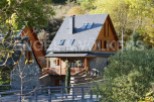 Charming stone house with wooden accents and a slate roof.