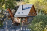 Charming stone house with wooden accents and a slate roof.