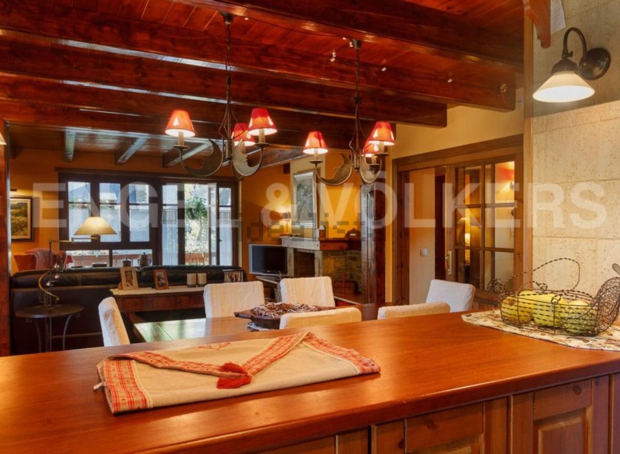 This stunning property boasts a spacious open-plan living area with exposed wooden beams, creating a warm and inviting atmosphere.