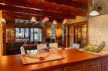 This stunning property boasts a spacious open-plan living area with exposed wooden beams, creating a warm and inviting atmosphere.