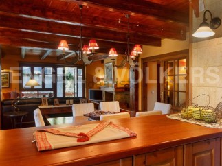 This stunning property boasts a spacious open-plan living area with exposed wooden beams, creating a warm and inviting atmosphere.